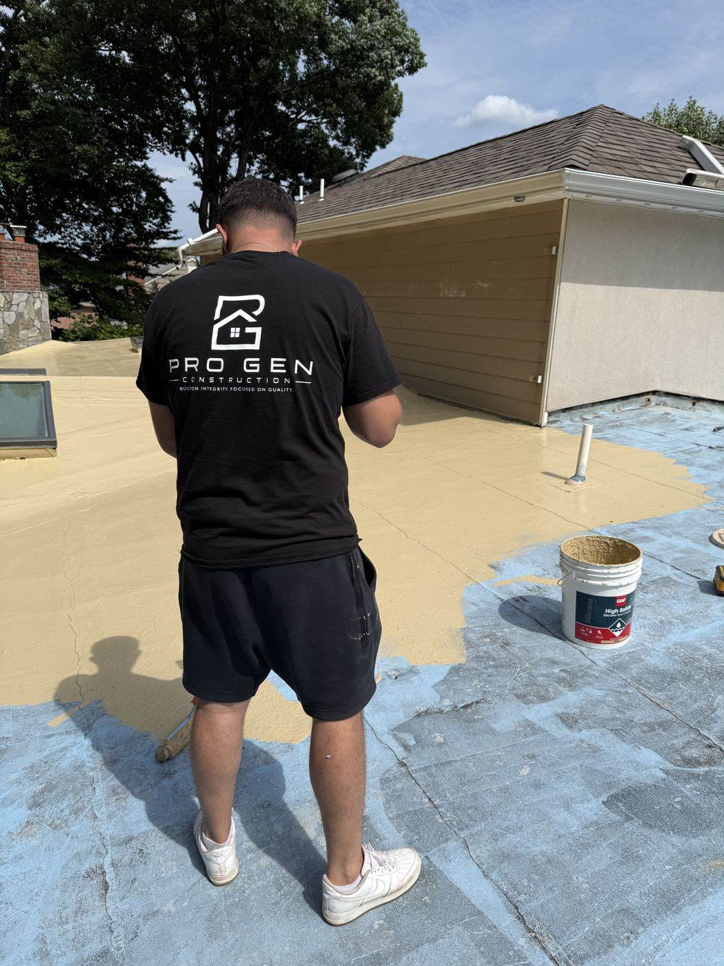 Pro Gen crew member on a freshly coated flat roof